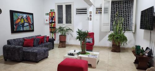 a living room with a couch and two chairs at Hotel Villa Ángel in Neiva