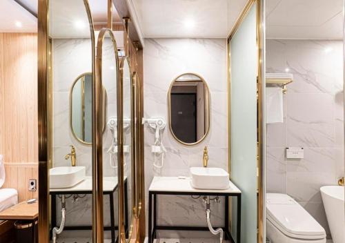 a bathroom with two sinks and mirrors and a toilet at No25 Doksan Intersection in Seoul