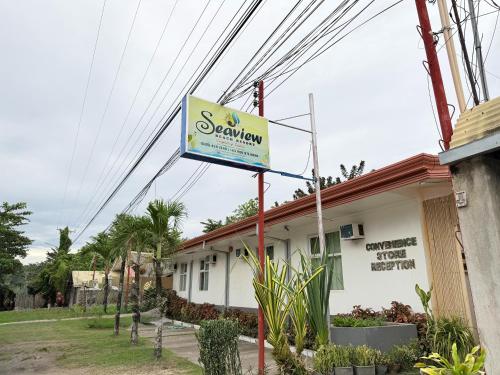 a sign for a restaurant in front of a building at Seaview Beach Resort Dumaguete Beachfront in Sibulan