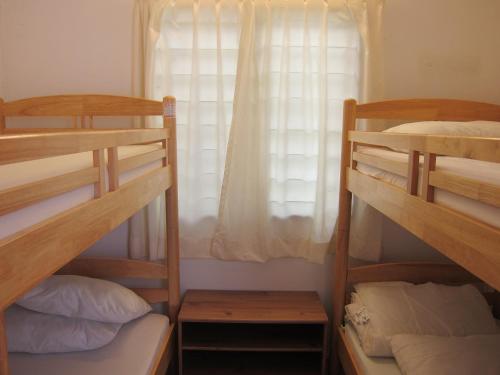 a bedroom with two bunk beds and a window at Moonriver Lodge in Cameron Highlands