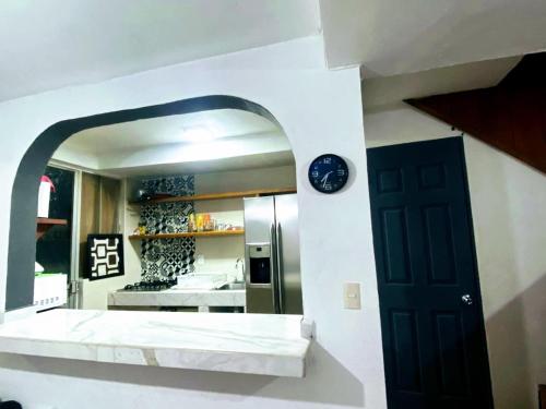 a kitchen with a black door and a mirror at Rent Casa La Moraleja in Ixtapa