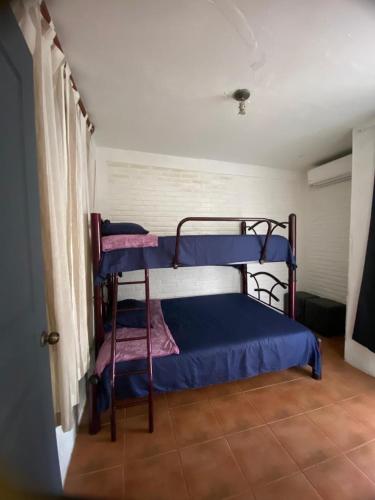 a bedroom with two bunk beds in a room at Rent Casa La Moraleja in Ixtapa
