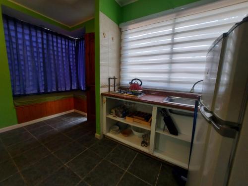 a kitchen with a sink and a window at Cabañas Alquymia in Algarrobo