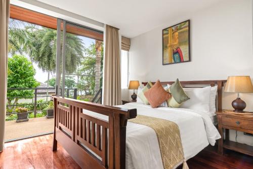 a bedroom with a bed and a balcony at Baan Leelawadee in Bophut