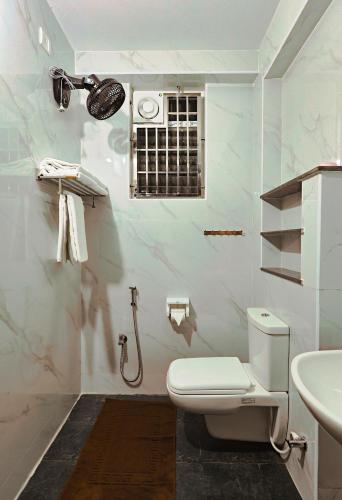 a bathroom with a toilet and a sink at Aashi-Premium Serviced Apartments in Chennai