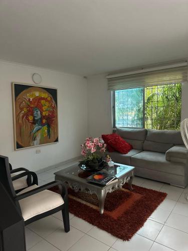 a living room with a couch and a table at Casa Cortijos in Valledupar