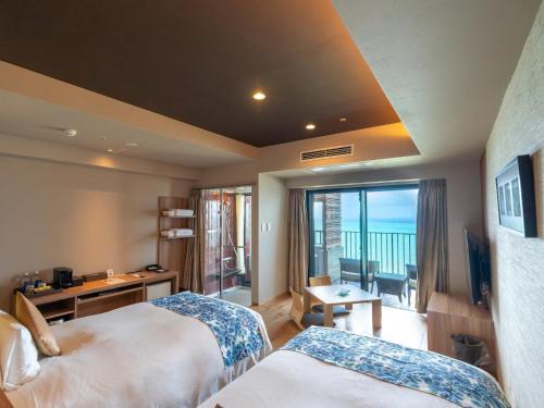 a hotel room with two beds and a balcony at Senagajima Island Resort & Spa in Tomigusuku