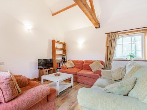 a living room with two couches and a tv at Leedale Cottage in Saltmarshe