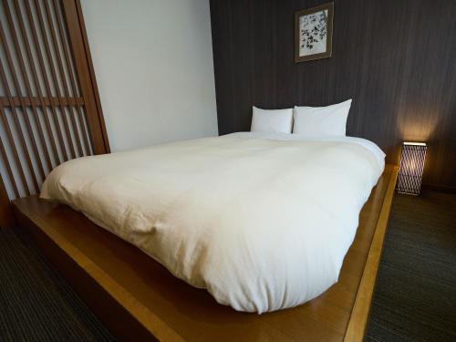 a large white bed in a hotel room at Nikko Station Hotel Classic in Nikko