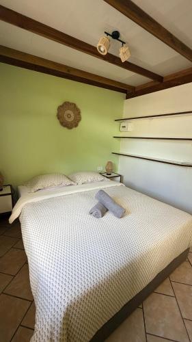 a bedroom with a bed with a towel on it at Vai Hea Lodge in Taputapuapea