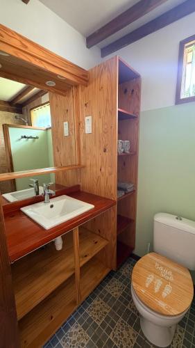 a bathroom with a sink and a toilet at Vai Hea Lodge in Taputapuapea