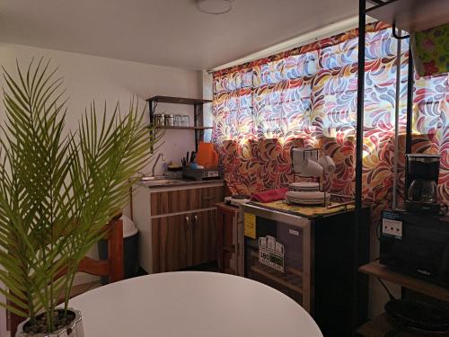 a room with a table and a flowered curtain at Rincon Hortensia apartments and loft in Oaxaca City
