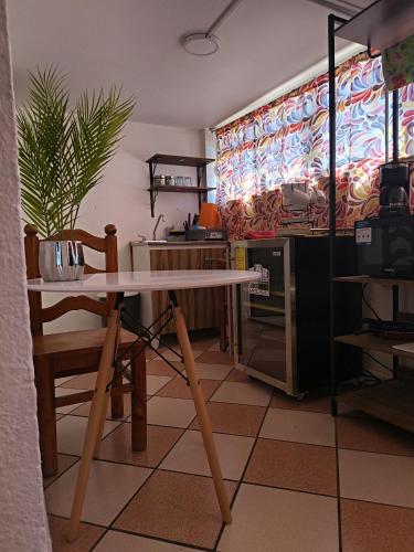 a table and a chair in a room at Rincon Hortensia apartments and loft in Oaxaca City