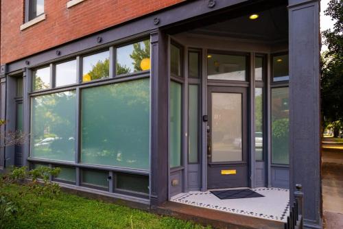 a house with glass doors on a building at Gorgeous 5BR Storefront Home ABODEbucks in Soulard