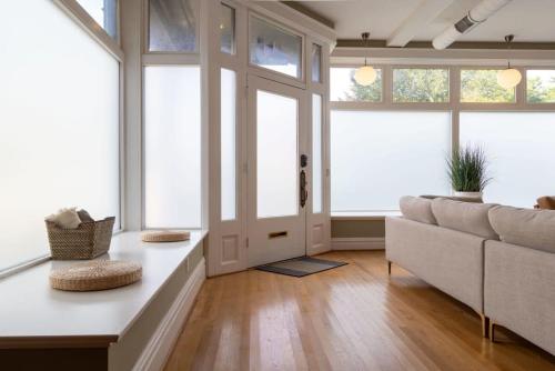 a living room with a couch and a table at Gorgeous 5BR Storefront Home ABODEbucks in Soulard
