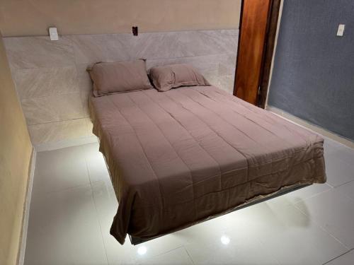 a small bed in a room with a large window at Complejo Residencial Las Lomitas in San Lorenzo de la Frontera
