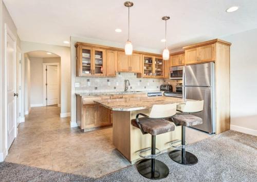 a kitchen with wooden cabinets and stainless steel appliances at Third-floor riverfront condo near downtown Bend in Bend