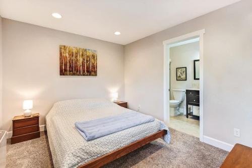 a bedroom with a bed and a bathroom at Third-floor riverfront condo near downtown Bend in Bend