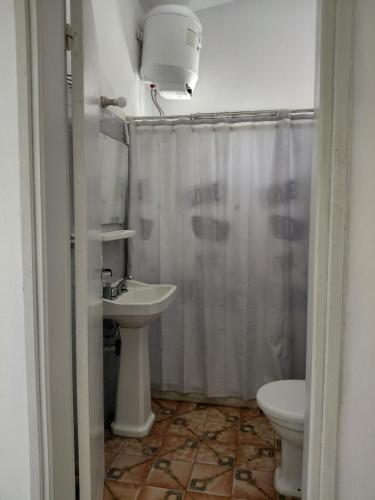 a bathroom with a sink and a toilet and a shower at Casa playera 2 dormitorios in La Paloma