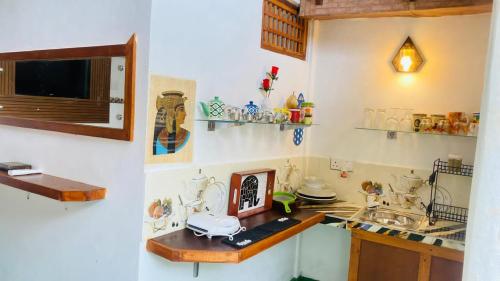 a kitchen with a sink and a counter top at Bliss Cottage in Gampola