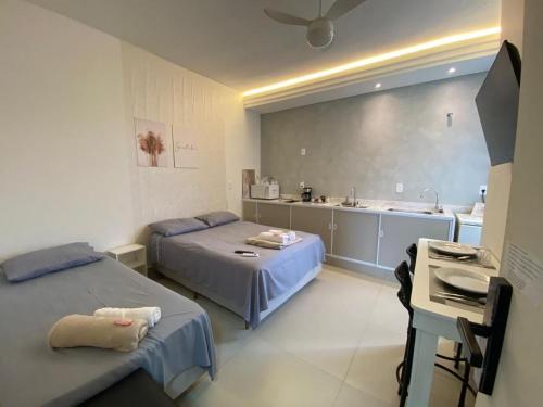 a hospital room with two beds and a kitchen at Hotel kitnet Digital in Passos