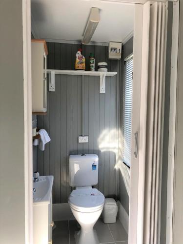 a small bathroom with a toilet and a sink at Shellharbour Holiday Village in Barrack Point