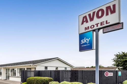 a sign for a motel in front of a house at Avon Motel in Hawera
