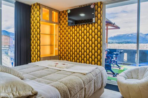 a bedroom with a bed and a large window at El Camino De Diego in Otavalo