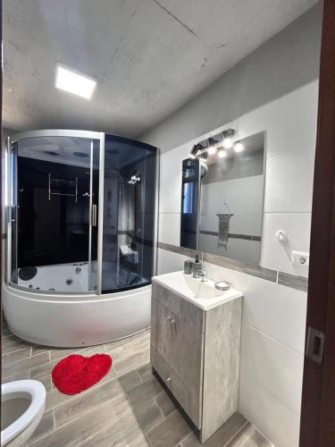 a bathroom with a sink and a toilet and a mirror at Chacra Piriápolis in Piriápolis