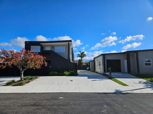 a house on a street with a driveway at Redwood Apartments in Rotorua