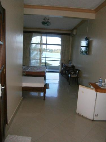 a room with a bed and a table and a window at Tudor Water Sports Hotel in Mombasa