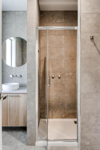 a shower with a glass door in a bathroom at Sixty - House 2 in Currie