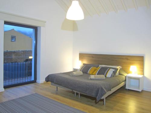 a bedroom with a large bed with a large window at Furnas Valley in Furnas