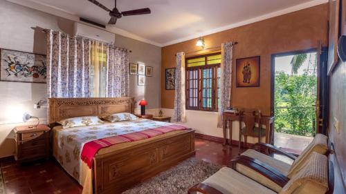 a bedroom with a large bed and a window at Sukrutham Farmstay in Trichūr