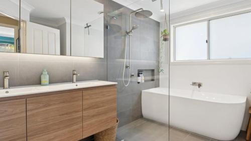 a bathroom with a sink and a tub and a shower at Boater's Retreat - pet friendly, right off the M1 in Toormina