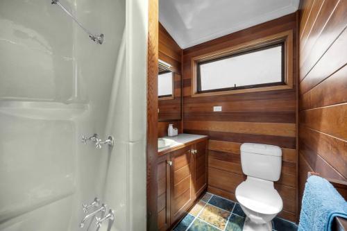 a bathroom with a toilet and a sink and a shower at Blenheim Beach Retreat in Vincentia