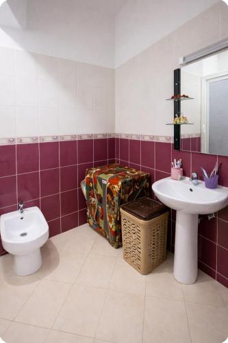 a bathroom with a toilet and a sink at Spacious Family-Friendly Apartment in Temara