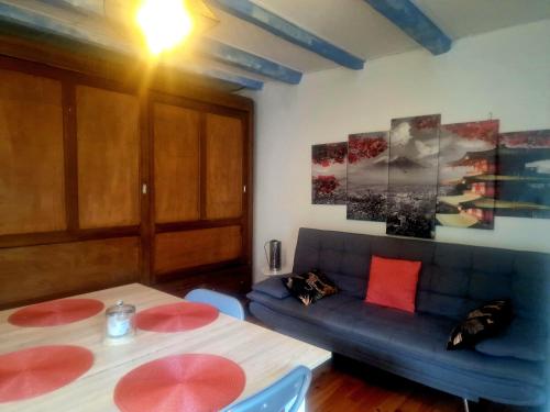 a living room with two tables and a couch at Appart Catalina La Mexicaine in Ucciani
