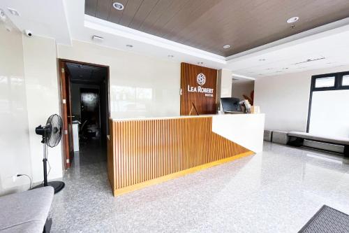 a lobby with a reception desk in a building at Lea Robert Hotel Angeles City in Angeles