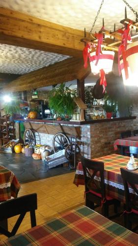a dining room with a table and a fireplace at Pyszna Stajenka in Bąków
