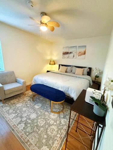 a bedroom with a king sized bed and a chair at Walk to Dodger St Echo Park Modern 2BR with 1Gbps Fiber Parking in Los Angeles