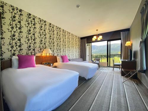 a hotel room with two beds and a television at Hakone Sengokuhara Prince Hotel in Hakone