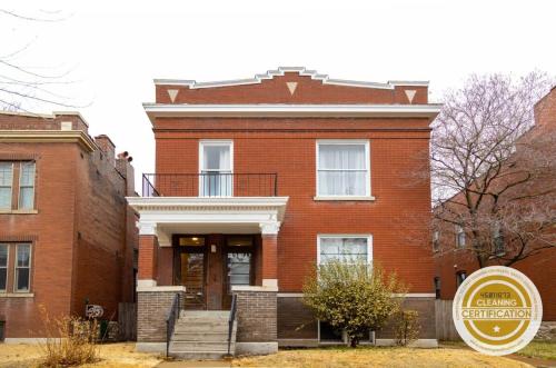 a brick building with a sign in front of it at Swanky Shaw 2BR with Office ABODEbucks in Tower Grove