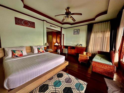 a bedroom with a bed and a ceiling fan at Haad Yao Bayview Resort & Spa - SHA plus Certified in Haad Yao