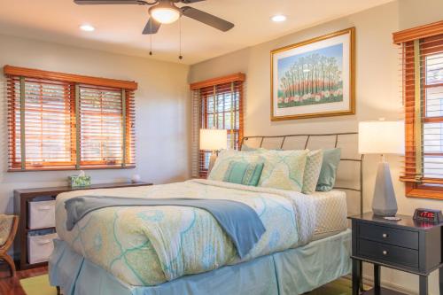 a bedroom with a bed and a ceiling fan at The Little Pumpkin Guest House in San Diego