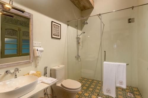 a bathroom with a sink and a toilet and a shower at Ridee Kandy in Kandy
