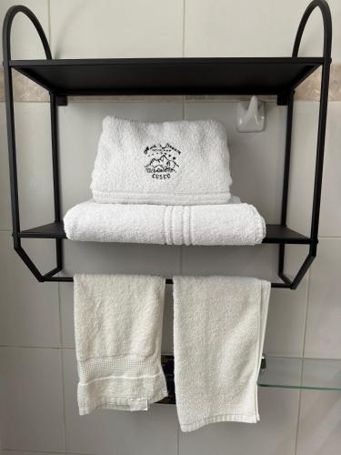 a group of towels on a shelf in a bathroom at Awki´s Dream Hotel in Cusco