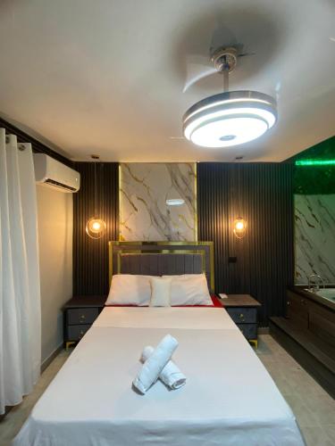 a bedroom with a large bed with two paper towels on it at Luxury and beautiful studio private jacuzzi in Santo Domingo