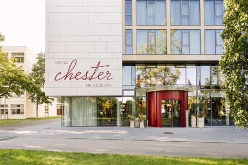 a building with a checker sign on the front of it at Chester Hotel Heidelberg in Heidelberg