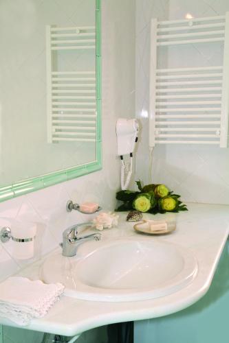 a bathroom with a sink and a mirror at Residence Dei Margi in Torre Faro
